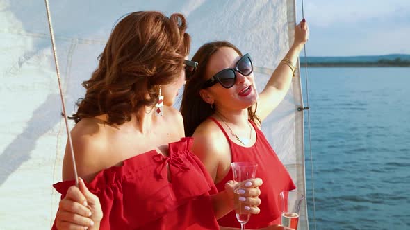 Cheerful Girls Talking at Party on Sailboat Deck