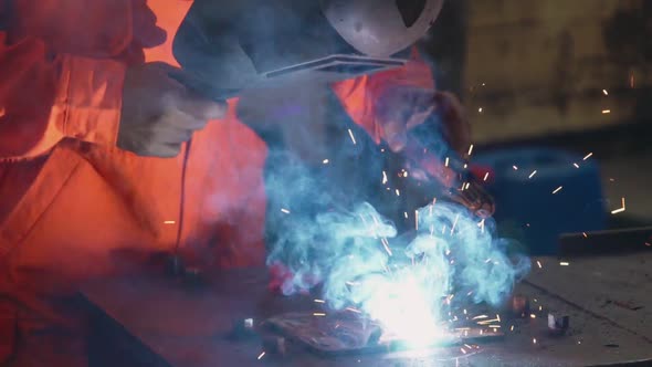 Metal Welder Working with Arc Welding Machine