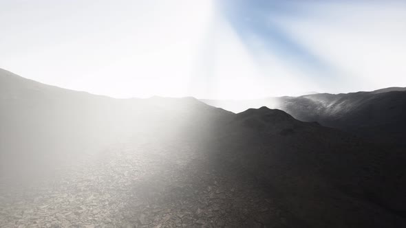 Sun Rays Over Mountains in a Valley