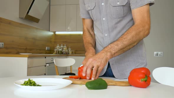 Slicing Red Bell Pepper on Wooden Cutting Board