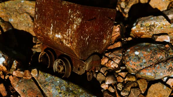 Abandoned Rusty Mine Cart on Rocks alt
