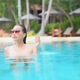 Young asian woman enjoy around outdoor swimming pool for leisure - VideoHive Item for Sale