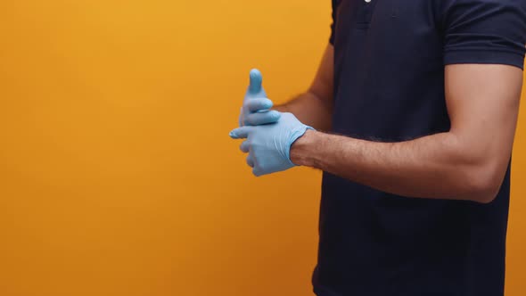 Man Putting on Latex Gloves