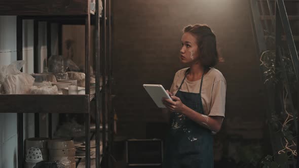 Ceramist Using Tablet Computer by Rack