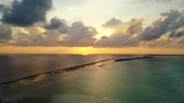 Aerial above scenery of beautiful coast beach journey by blue lagoon with bright sand background of 