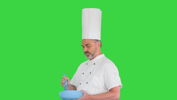 Male Chef Cook Holding Bowl and Whipping Something with Whisk on a Green Screen Chroma Key