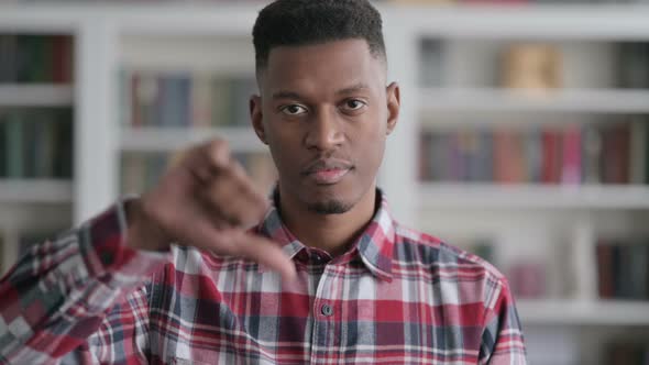 Portrait of African Man showing Thumbs Down Gesture