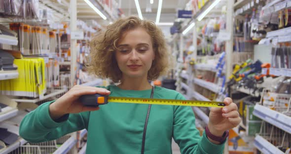 Young Woman Choose Measure Tape in Diy Store