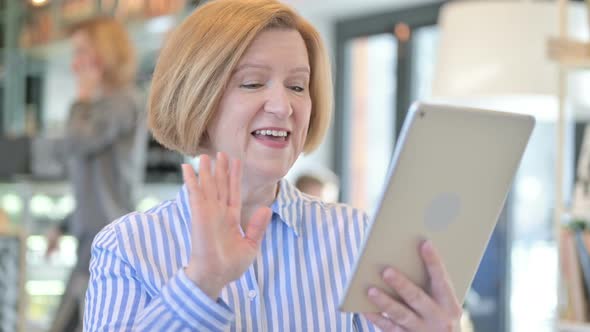 Portrait of Video Chat on Tablet By Creative Old Woman 