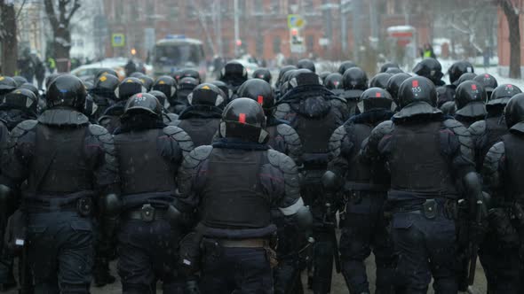 Riot Police Officers Walking in Wall Line Formation Patrolling Rallying Street