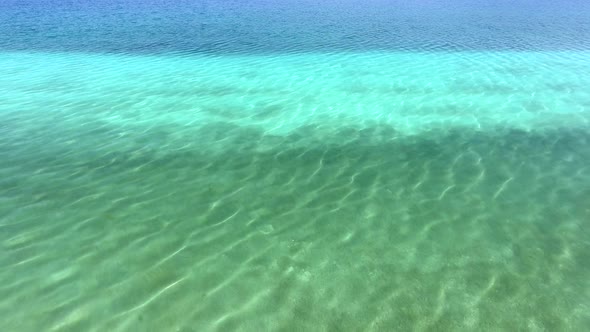 White Sandy Coral Reef in the Clear Turquoise Light Blue Sea of the Tropical Coastline