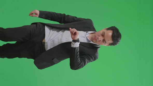 Asian Business Man Walking While Looking At Watch And Run On Green Screen Chroma Key