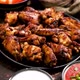 Grilled Chicken Wings on a Black Plate on a Dark Rustic Background - VideoHive Item for Sale