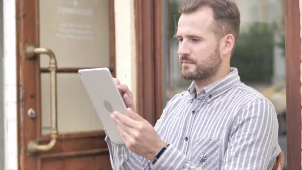 Beard Casual Man Using Tablet Outdoor