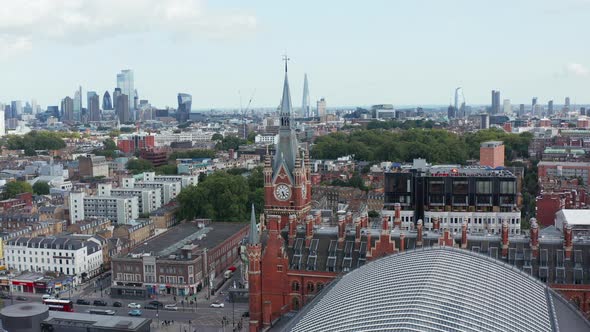 Aerial Panoramic View with Red Brick Clock Tower in Foreground and Modern Tall Skyscrapers in