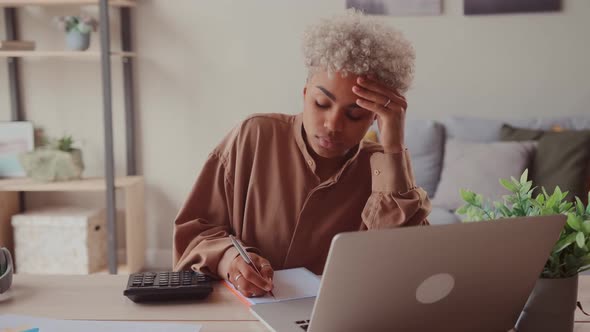 African Woman Accounting Managing Personal Finances in Computer e Banking App