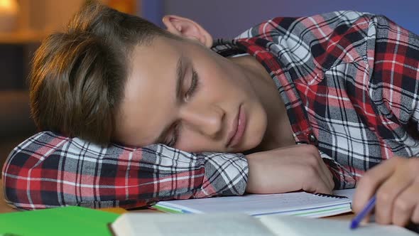 Tired Schoolboy Sleeping on Table, Preparation for Exam, Overworked Student