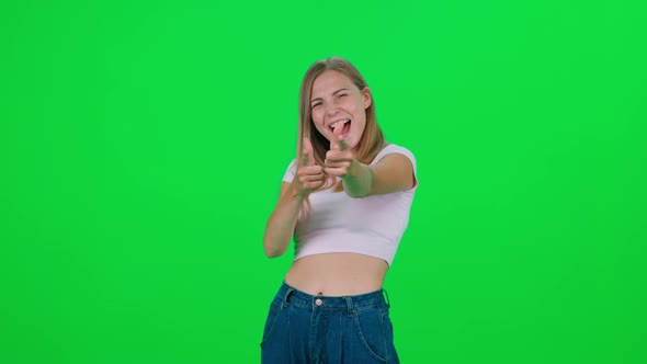 Caucasian Female Standing in Green Room and Looks at the Camera Chroma Key Background the Young