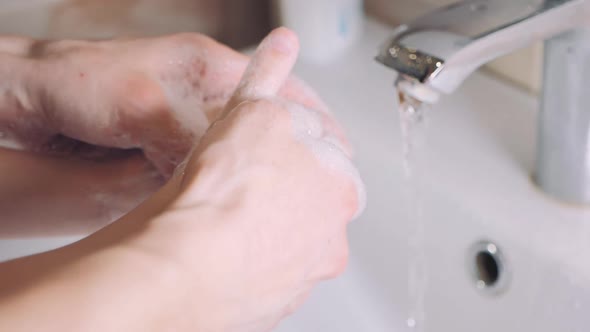 Mother with Little Son Washing Hands Together