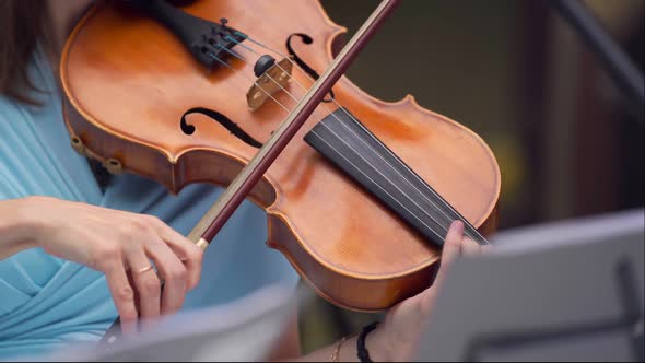 Symphony Orchestra with Performers Wearing Medical Protective Masks Playing Violins Cello and