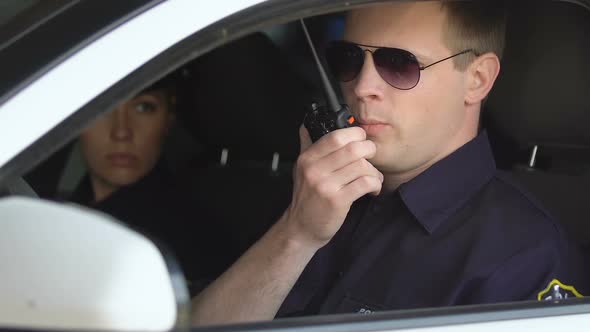 Male and Female Cops Sitting in Patrol Car Accepting Emergence Call, Enforcement