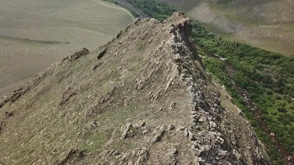 Top View Drone Footage Flying Over High Peak in National Reserve Park.