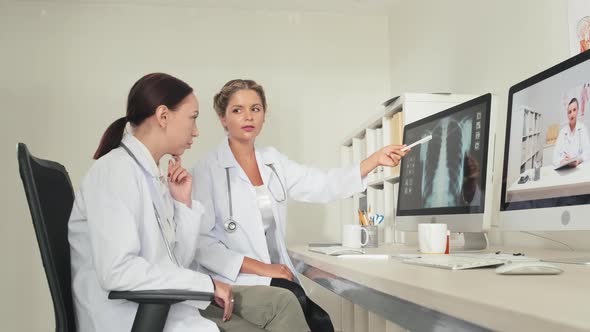 Female Doctors Analyzing Chest X Ray Image on Computer