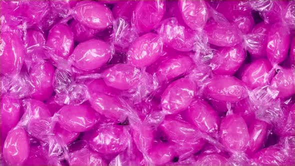 Bowl Of Pink Candies In Wrappers