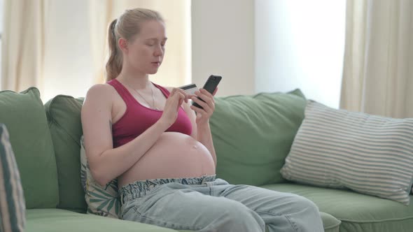 Pregnant Woman Making Online Payment on Smartphone