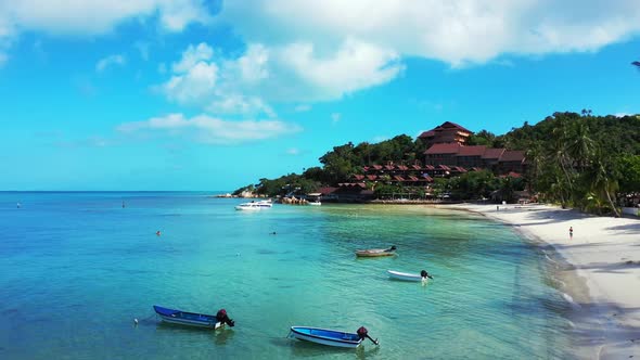 Aerial drone view seascape of perfect shore beach voyage by aqua blue ocean with white sand backgrou