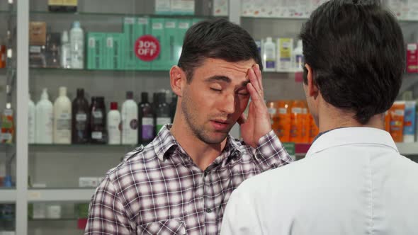 Attractive Young Man Shopping for Headache Medications