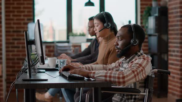 African American Employee Using Headphones to Talk to Clients