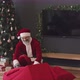 Santa Putting Presents under Christmas Tree - VideoHive Item for Sale