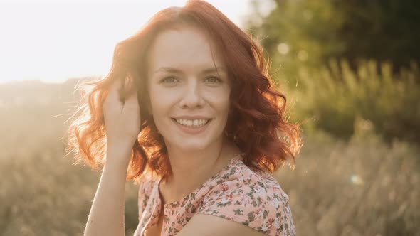 Closeup Portrait of a Beautiful Redhead Girl at Sunset