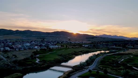Hyperlapse of a sunset in an idyllic community along a golf course and river with the sky reflecting