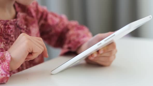 Little Girl Playing on Digital Tablet