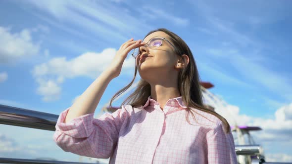 Inspired Woman Listening to Music in Headphones, Watching Confidently in Future