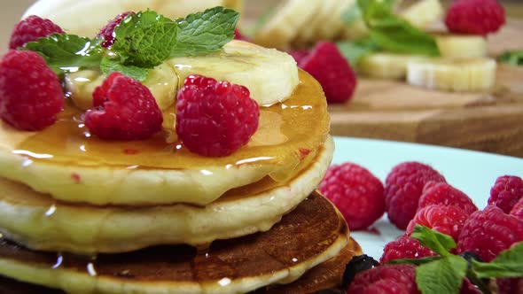 Pouring Honey on Stack of Pancakes