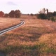 Active young cyclist on a bicycle rides along crosscountry road in a field at sunset on a summer day - VideoHive Item for Sale
