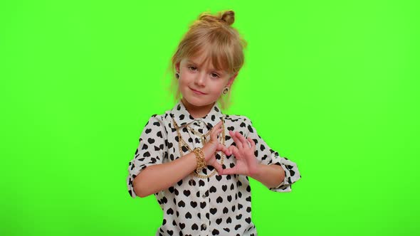 Smiling Child Girl Makes Heart Gesture Demonstrates Love Sign Expresses Good Feelings and Sympathy