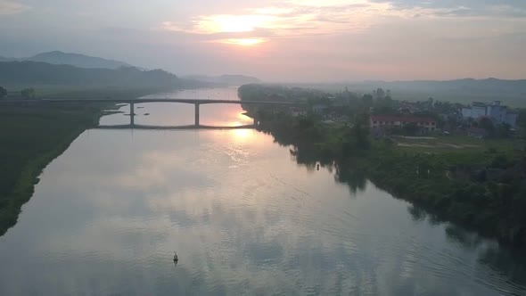 Tropical River Under Narrow Bridge Against Summer Sunset