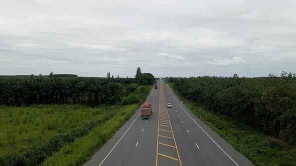 Low angle aerial view of highway in countryside on cloudy day, forwardement