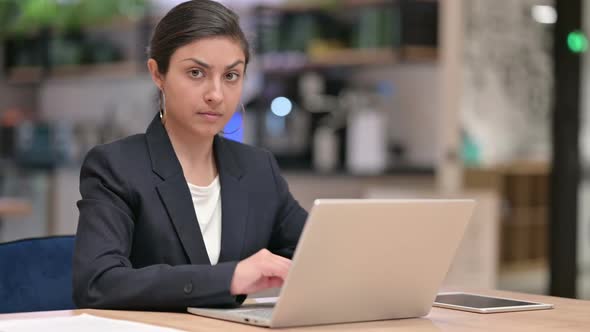 Attractive Young Indian Businesswoman with Laptop Showing No Sign