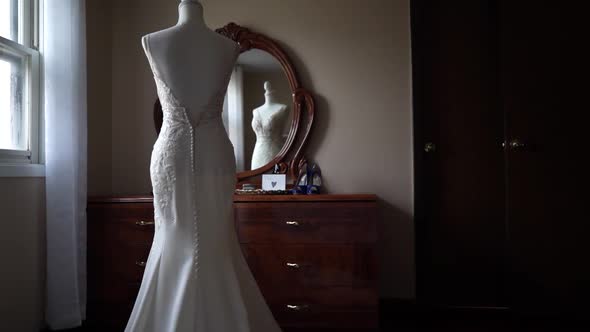 Couture Gowns Displayed on Mannequins in Bridal Wear Store a Bride Trying on Her Dress Reflected in