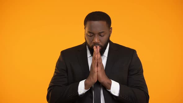 African-American Businessman Praying for Successful Deal, Important Meeting