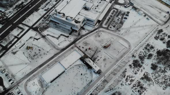 A Lot of People Skate on the Ice Rink in Open Street