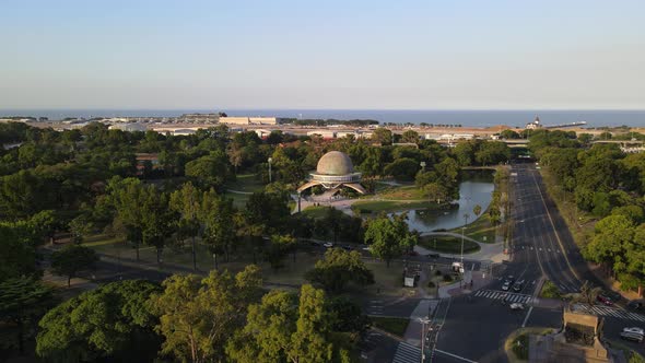 Pan left of Galileo Galilei Planetarium surrounded by Palermo Woods and Rio de la Plata river in bac
