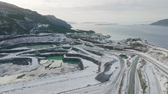 Large Snowy Stone Mining Industrial Quarry Pit In Norway, Aerial Orbit