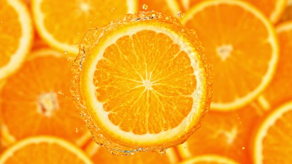 Super Slow Motion Shot of Splashing Water From Rotating Orange Slice at 1000Fps.