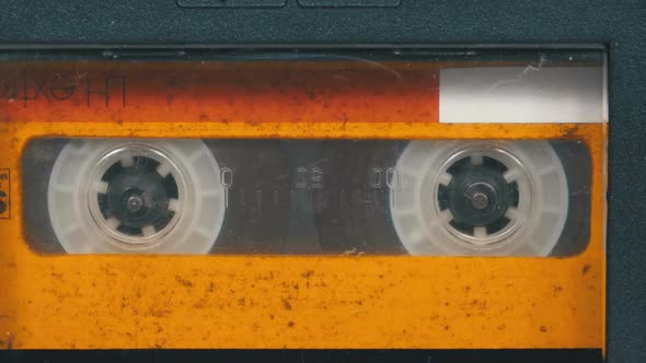 The Vintage Yellow Audio Cassette in the Tape Recorder Rotates